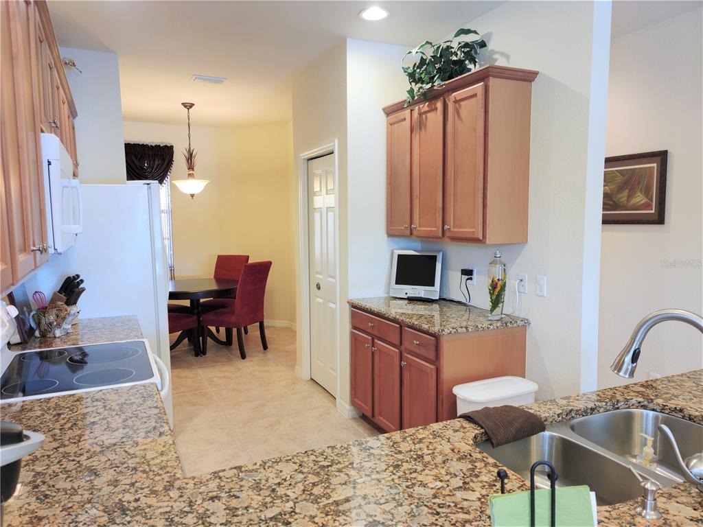 11997 Tempest Harbor Loop Venice, FL 34292 - Photo 21 of 52 a living room with furniture a piano and a flat screen tv
