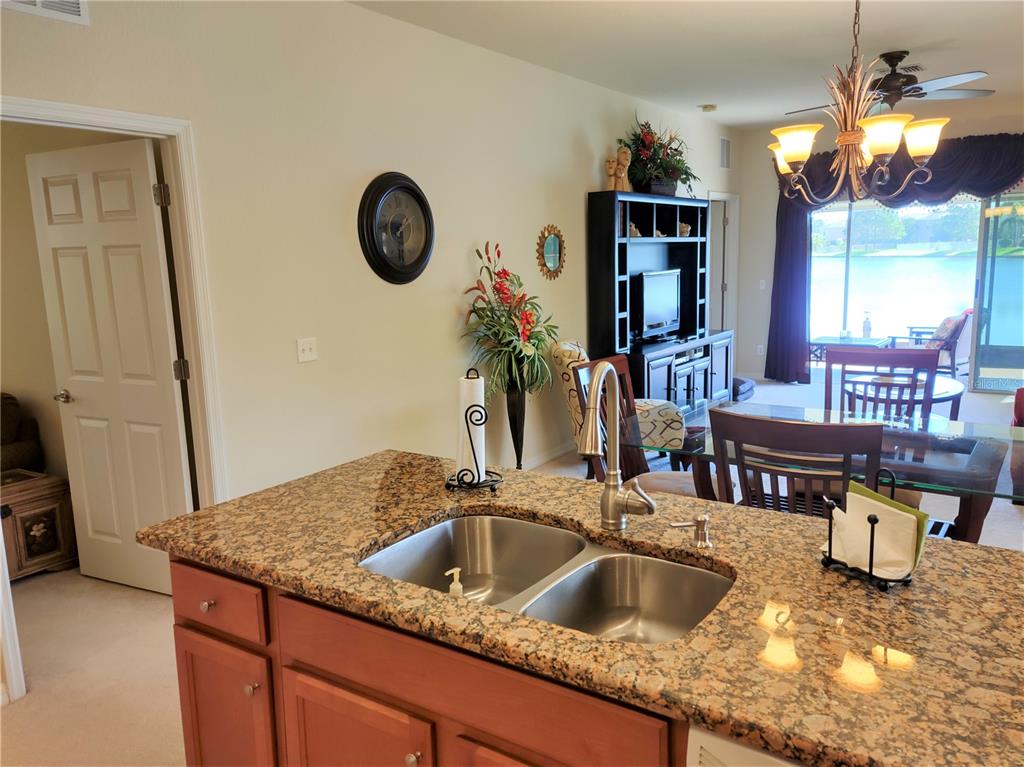 11997 Tempest Harbor Loop Venice, FL 34292 - Photo 27 of 52 a kitchen with a faucet a sink and a refrigerator