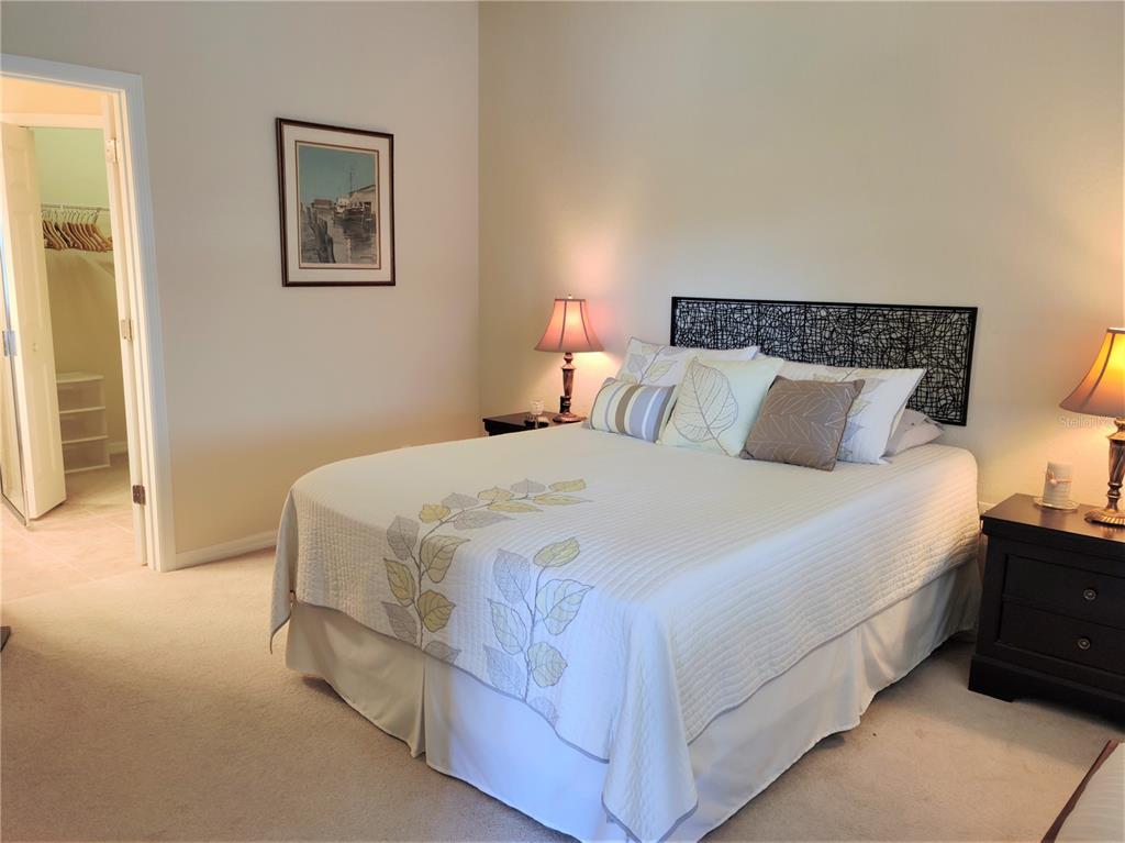 11997 Tempest Harbor Loop Venice, FL 34292 - Photo 30 of 52 a bedroom with a bed and a night stand