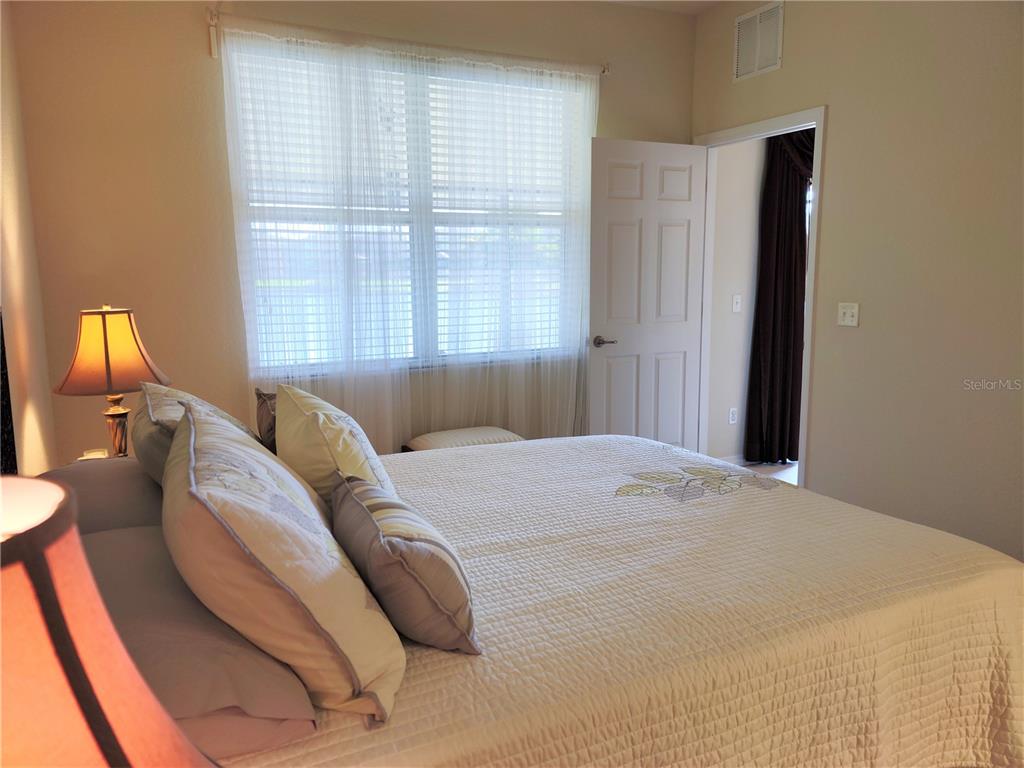 11997 Tempest Harbor Loop Venice, FL 34292 - Photo 31 of 52 a bed sitting in a bedroom next to a window