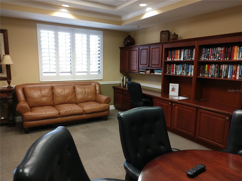 11997 Tempest Harbor Loop Venice, FL 34292 - Photo 51 of 52 a living room with furniture and a book shelf