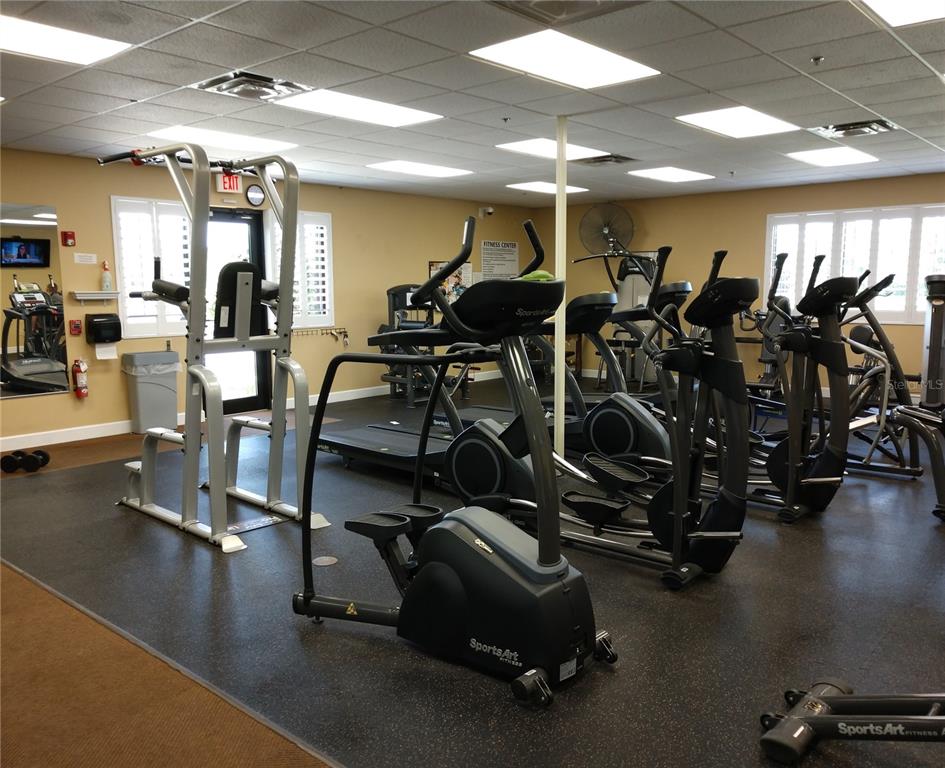 11997 Tempest Harbor Loop Venice, FL 34292 - Photo 52 of 52 a room with gym equipment and a large window