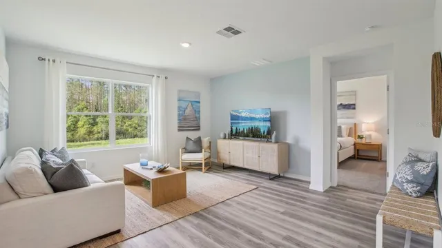 a living room with furniture and a large window