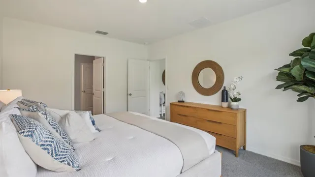 a bedroom with a bed and a dresser