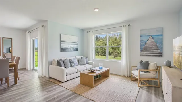 a living room with furniture and a large window