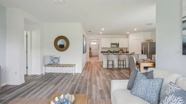 a living room with furniture and kitchen view