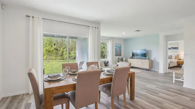 a view of a dining room with furniture window and wooden floor
