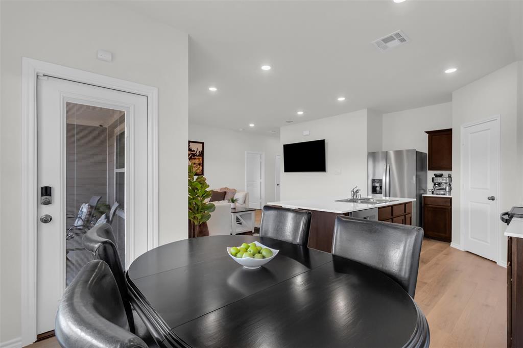 6513 Waterfall Lane Princeton, TX 75407 - Photo 12 of 35 a large kitchen with a table and chairs