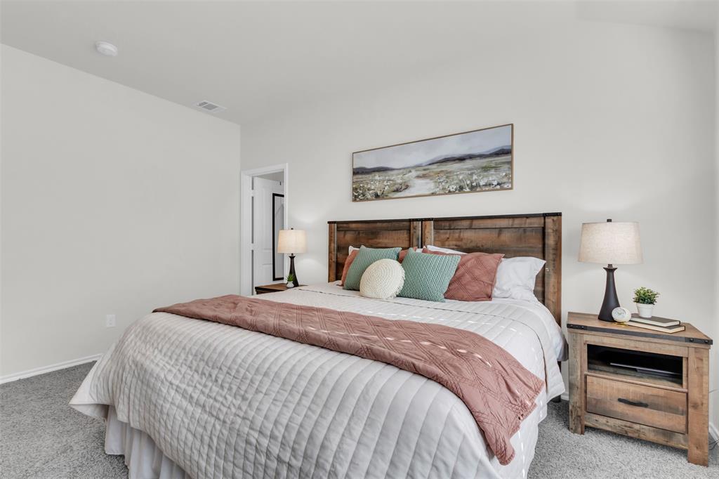 6513 Waterfall Lane Princeton, TX 75407 - Photo 14 of 35 a bedroom with a bed and a night stand