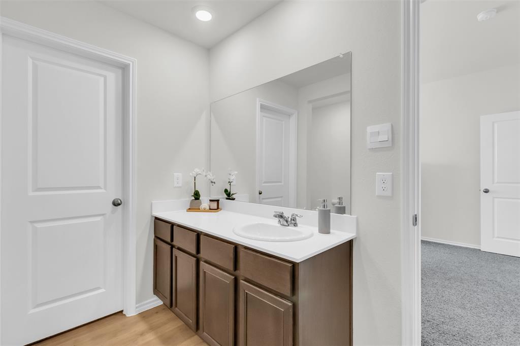 6513 Waterfall Lane Princeton, TX 75407 - Photo 16 of 35 a bathroom with a sink and a mirror