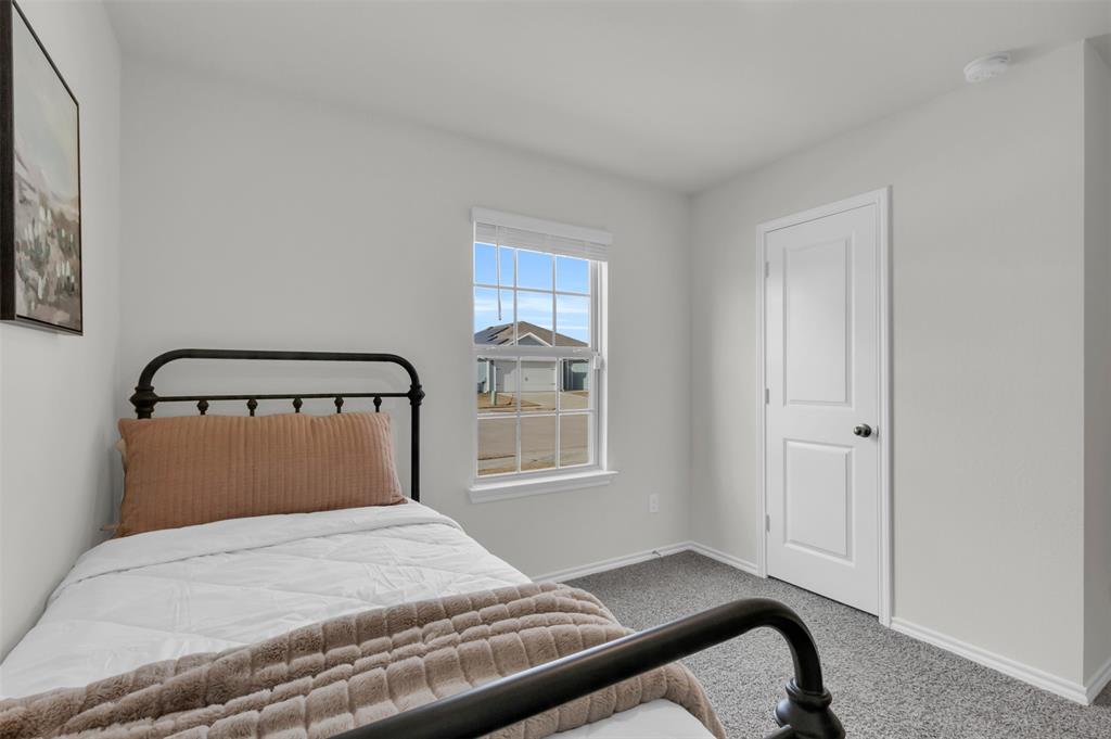 6513 Waterfall Lane Princeton, TX 75407 - Photo 18 of 35 a bedroom with a bed and window