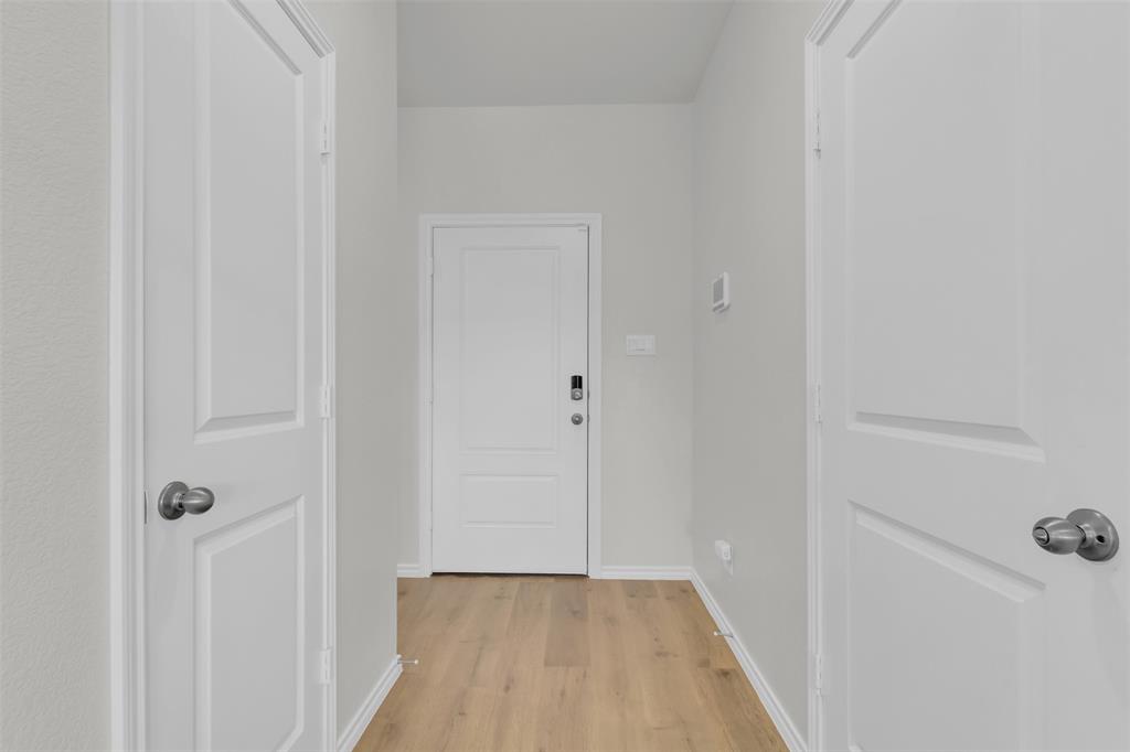 6513 Waterfall Lane Princeton, TX 75407 - Photo 21 of 35 a view of a hallway with wooden floor