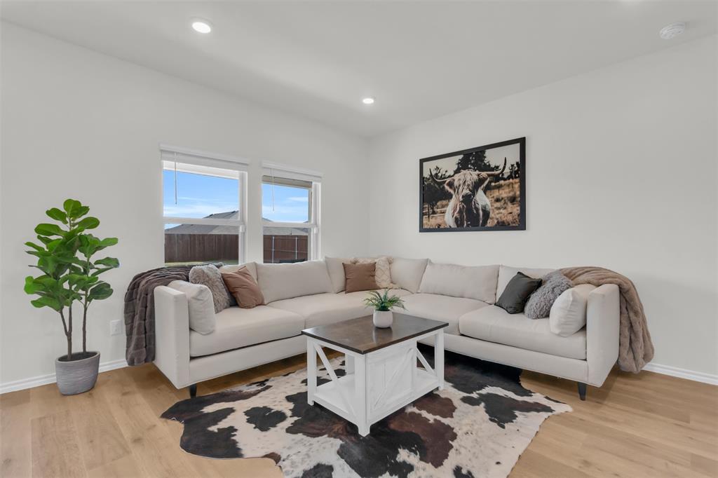 6513 Waterfall Lane Princeton, TX 75407 - Photo 3 of 35 a living room with furniture and a potted plant