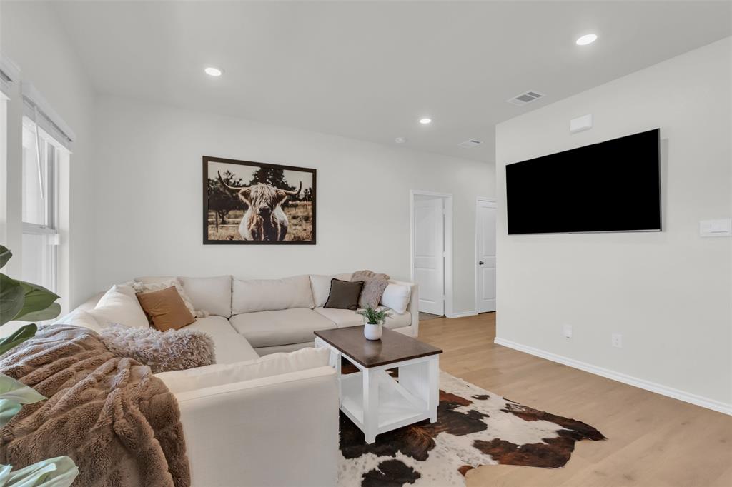6513 Waterfall Lane Princeton, TX 75407 - Photo 4 of 35 a living room with a flat screen tv and a couch