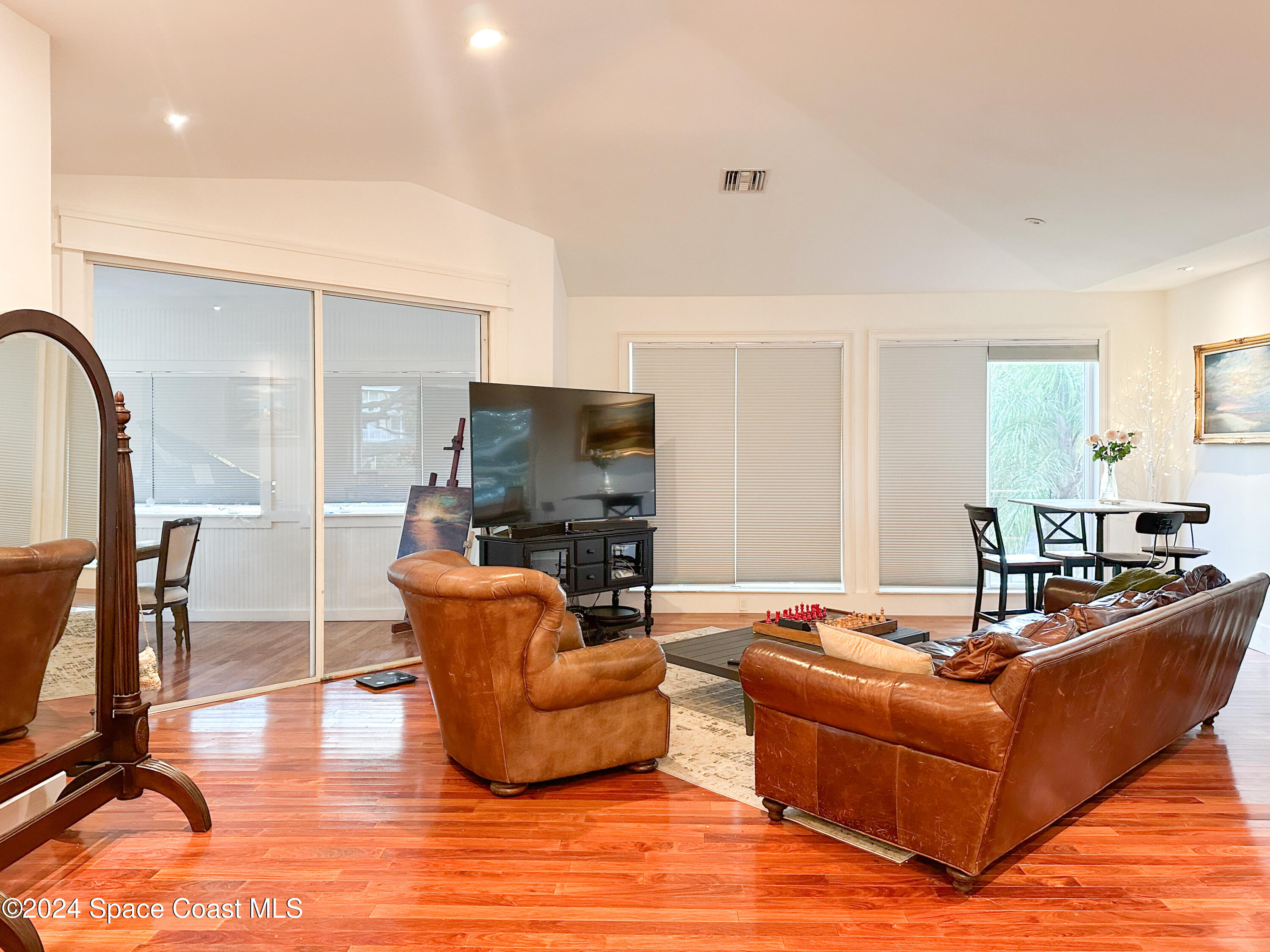 143 Caledonia Drive Melbourne Beach, FL 32951 - Photo 14 of 57 a living room with furniture kitchen view and a large window