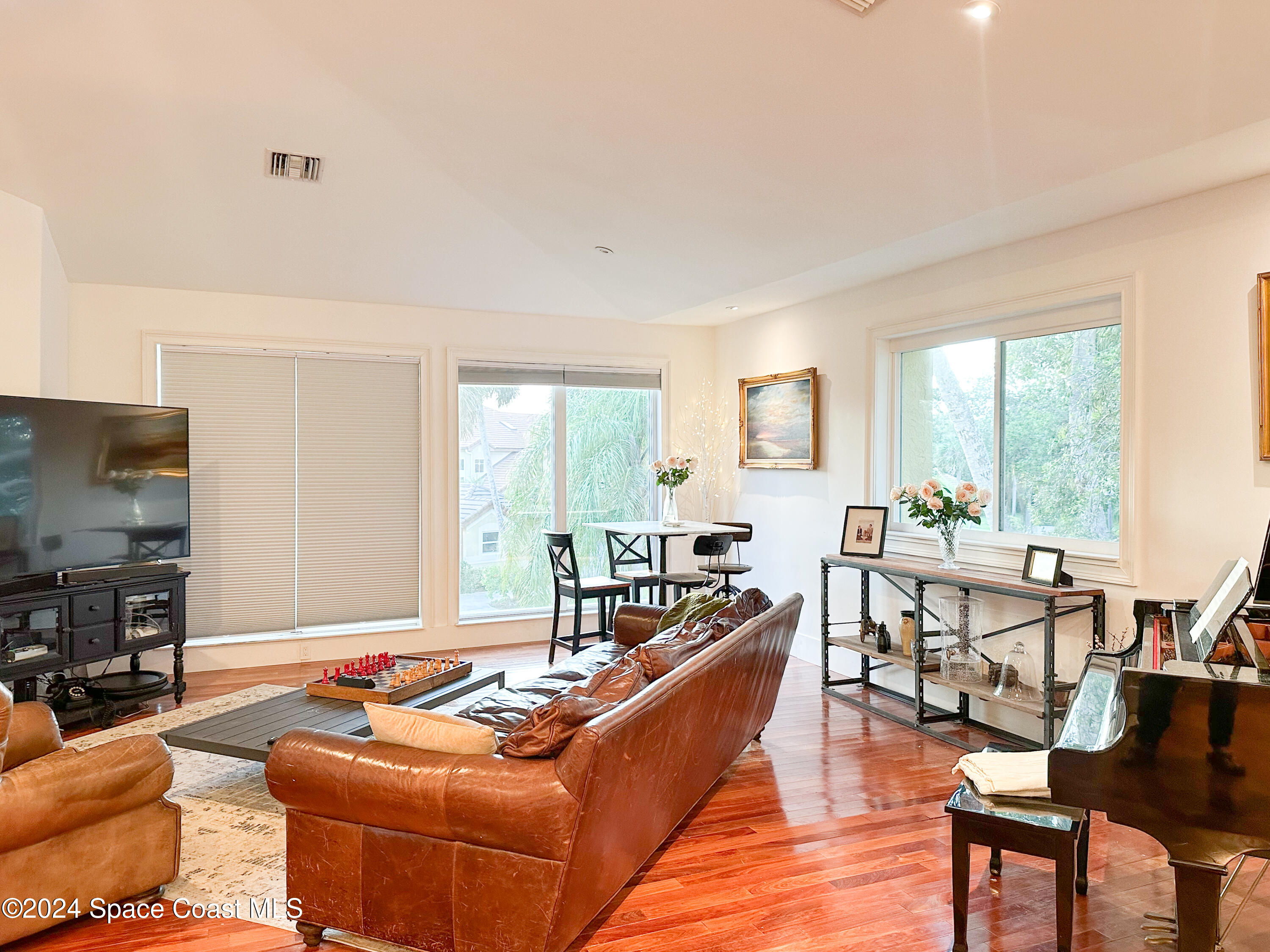 143 Caledonia Drive Melbourne Beach, FL 32951 - Photo 15 of 57 a living room with furniture and a flat screen tv