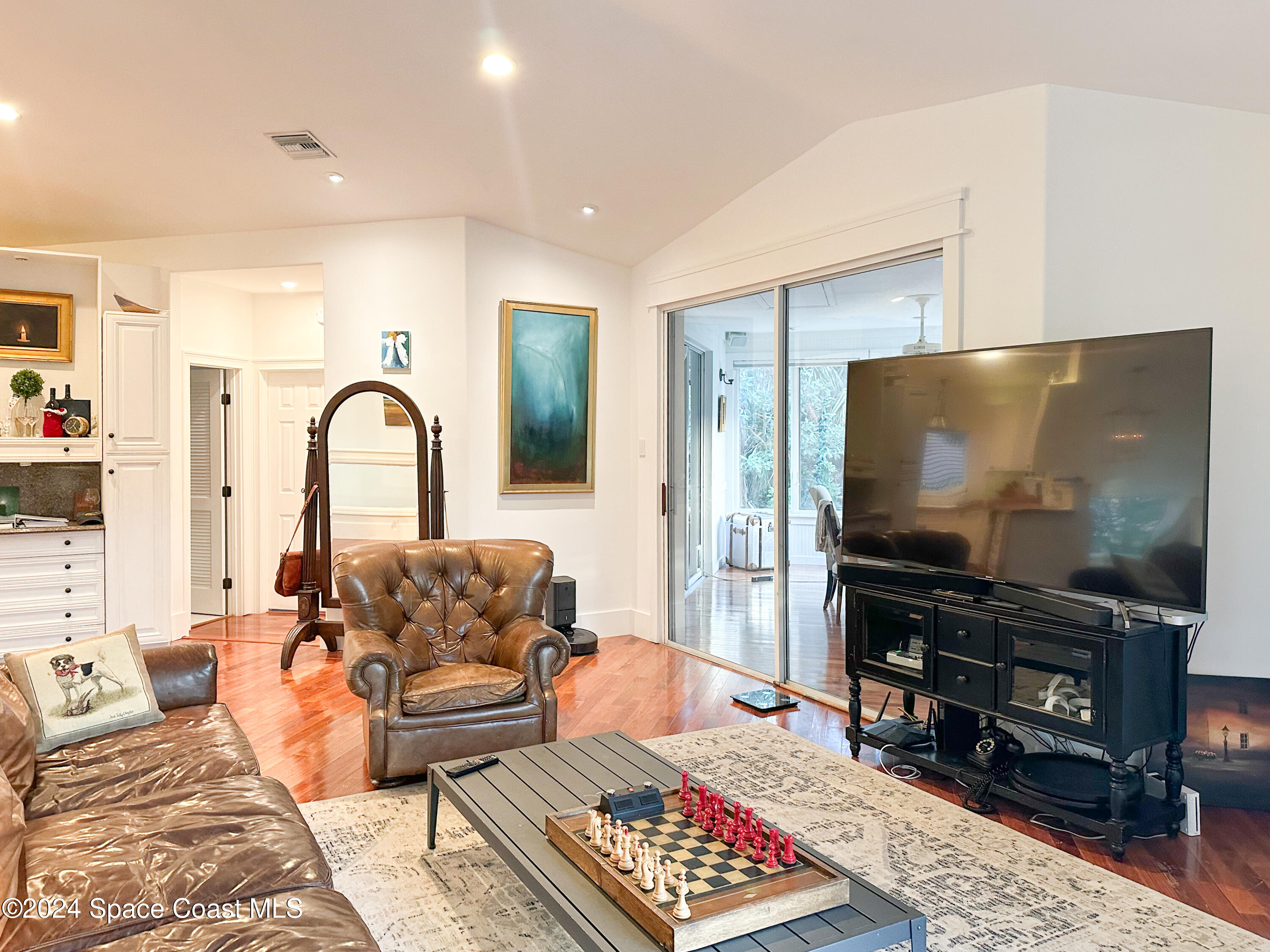 143 Caledonia Drive Melbourne Beach, FL 32951 - Photo 18 of 57 a living room with furniture and a flat screen tv