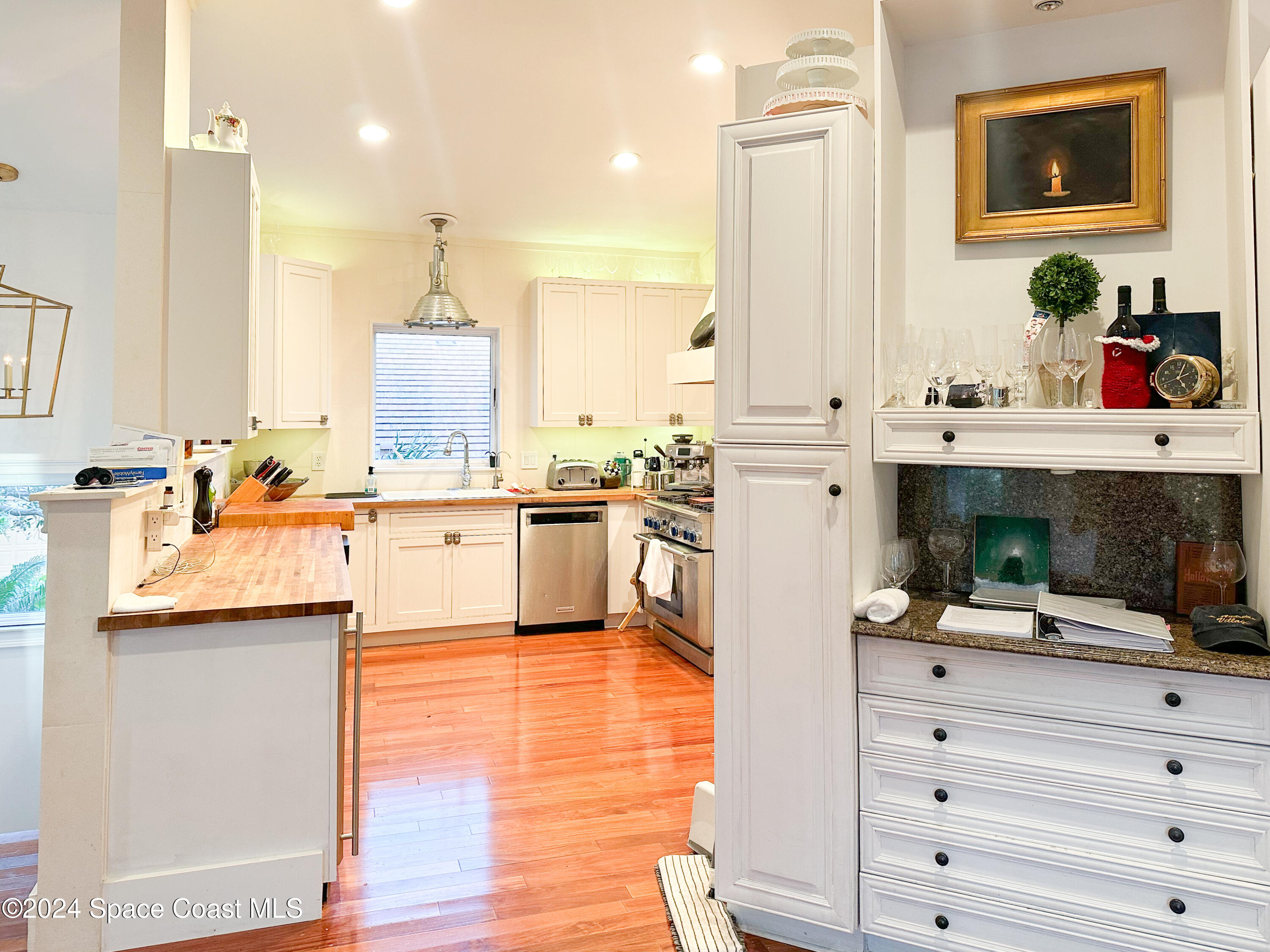 143 Caledonia Drive Melbourne Beach, FL 32951 - Photo 20 of 57 a kitchen with a sink stainless steel appliances and cabinets