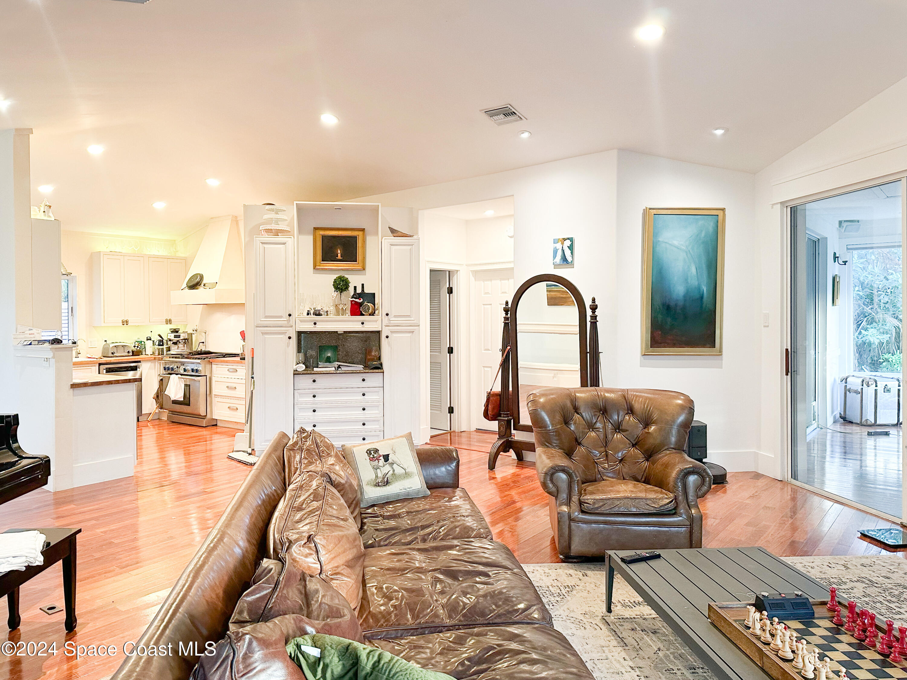 143 Caledonia Drive Melbourne Beach, FL 32951 - Photo 23 of 57 a living room with furniture and a potted plant