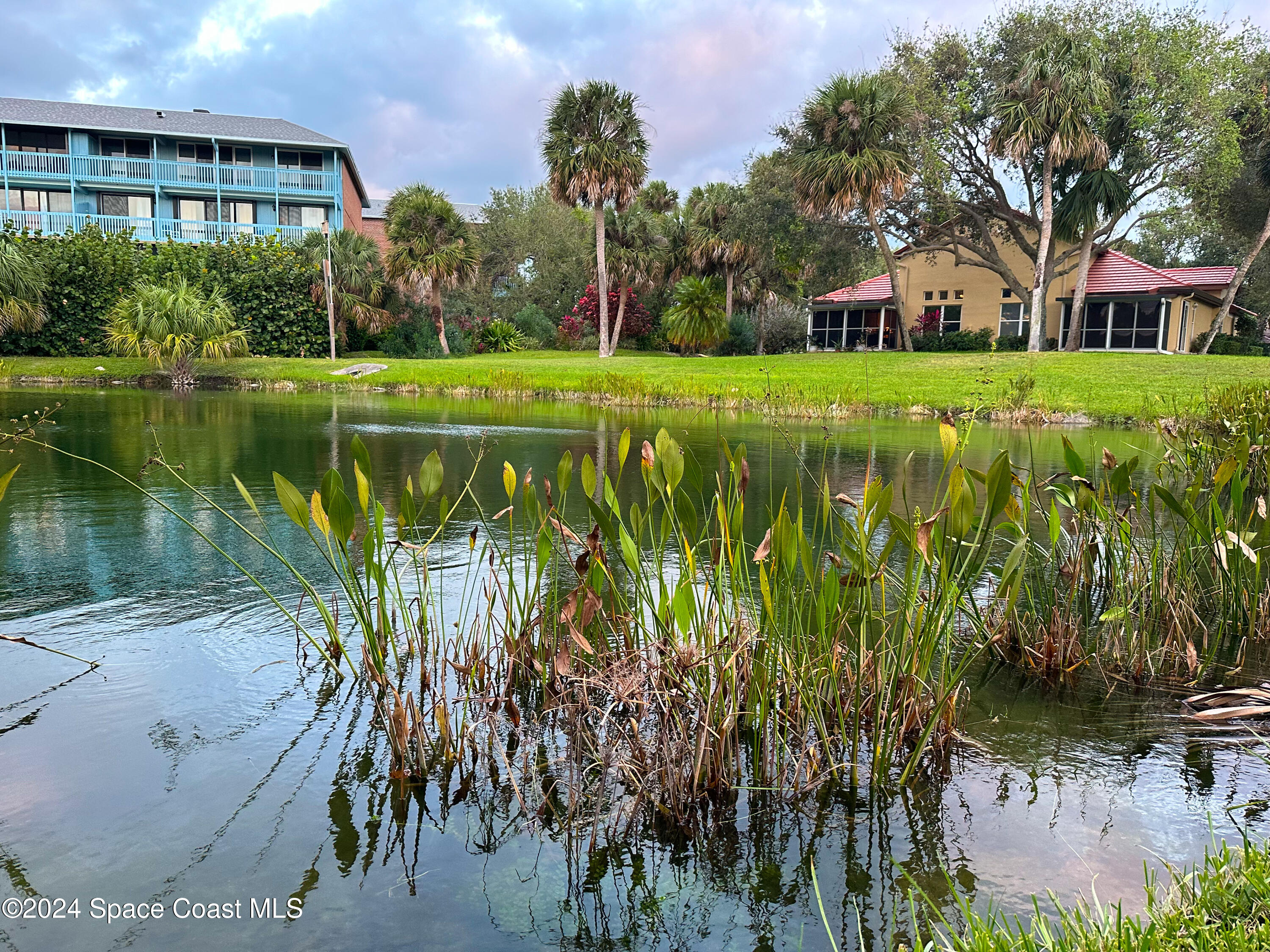 143 Caledonia Drive Melbourne Beach, FL 32951 - Photo 51 of 57 a view of a lake with a building in front of it