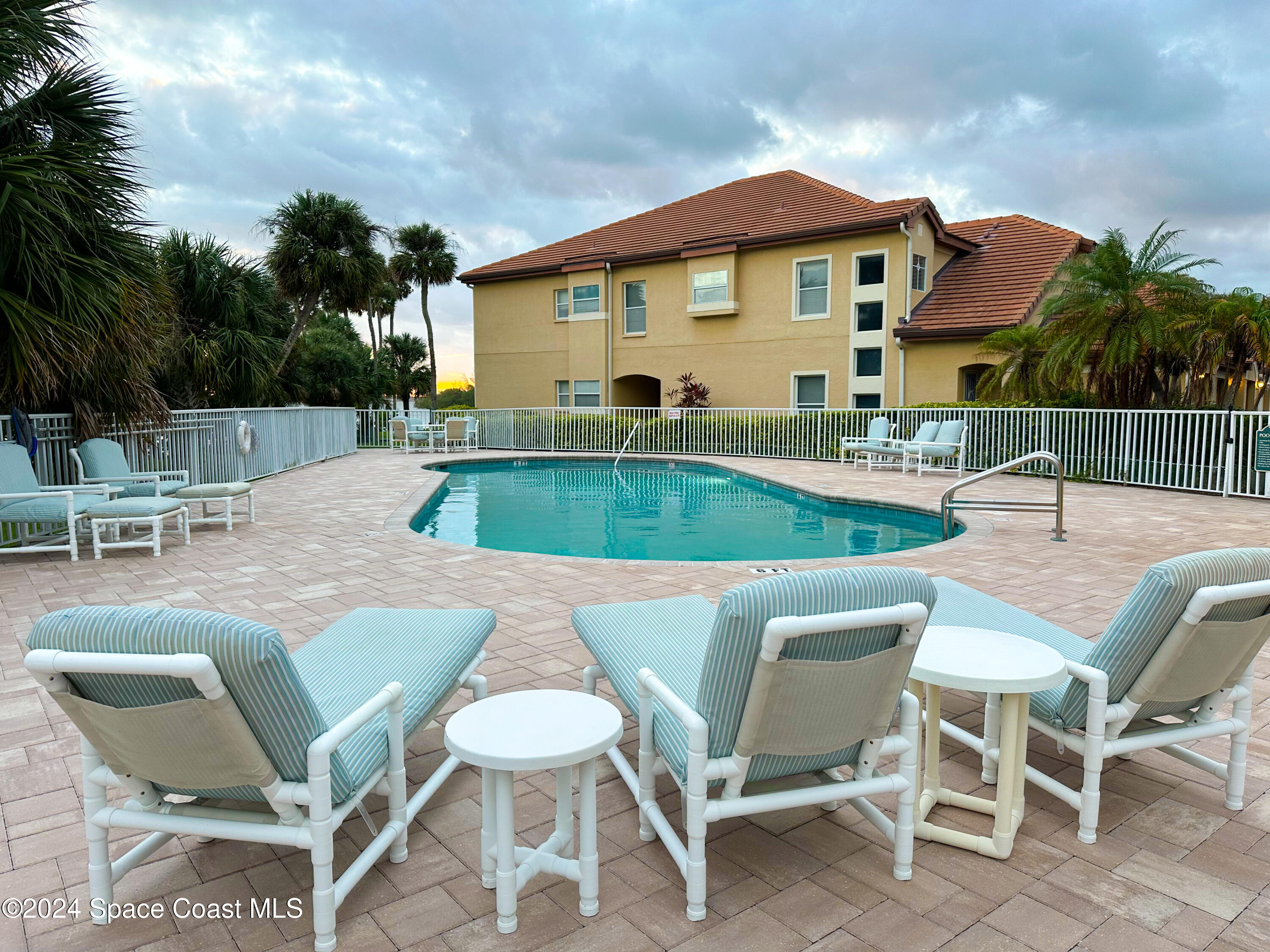 143 Caledonia Drive Melbourne Beach, FL 32951 - Photo 53 of 57 a view of a chairs and table in patio with a fire pit