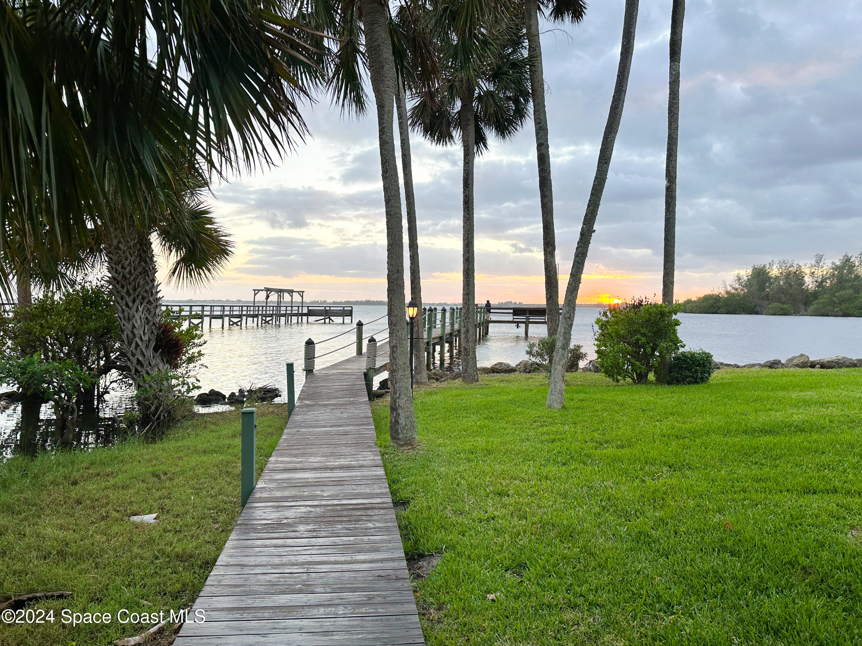 143 Caledonia Drive Melbourne Beach, FL 32951 - Photo 55 of 57 a view of a garden with a lake