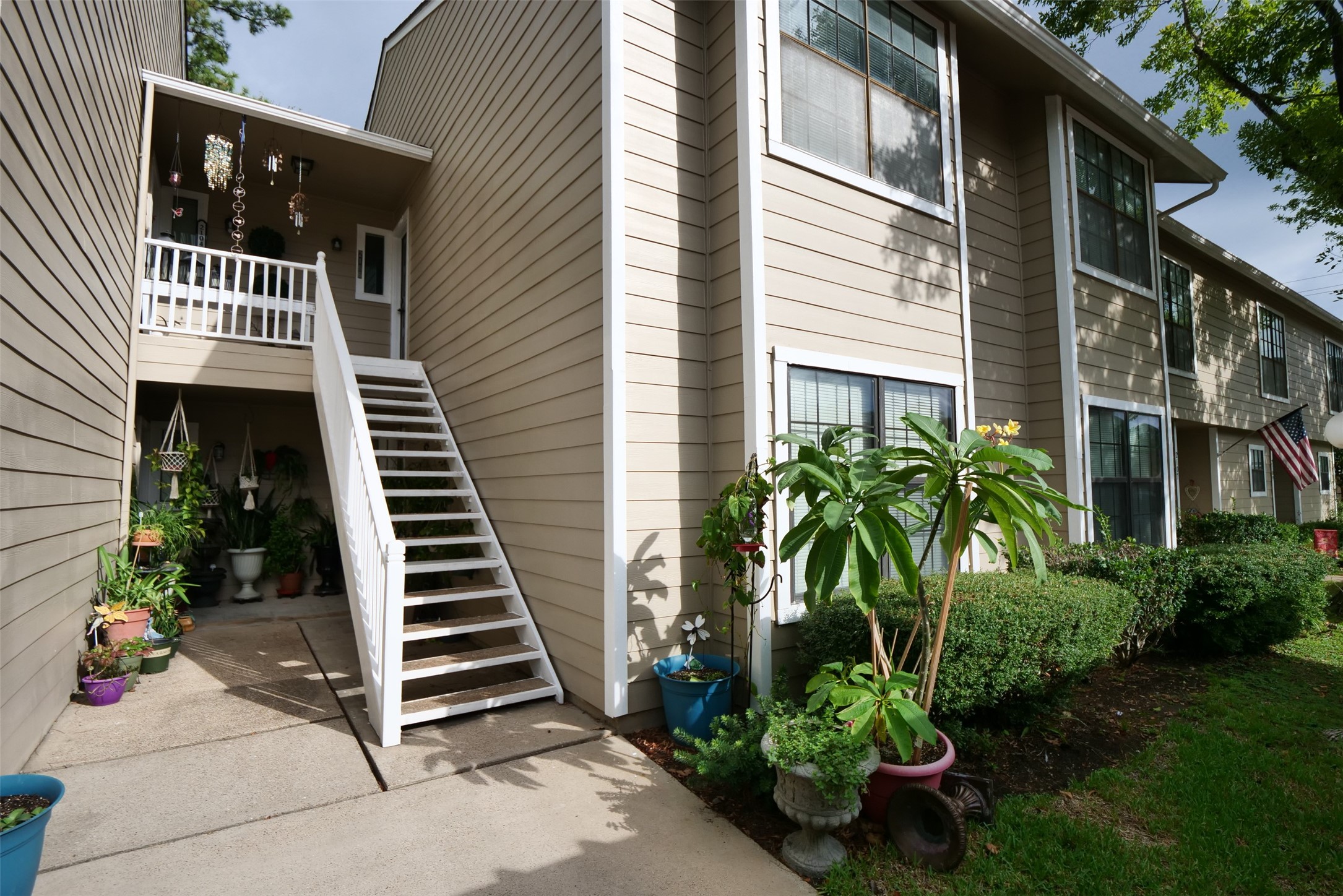 14911 Wunderlich Drive, Unit 2105 Houston, TX 77069 - Photo 1 of 24 a view of a entryway with flower plants