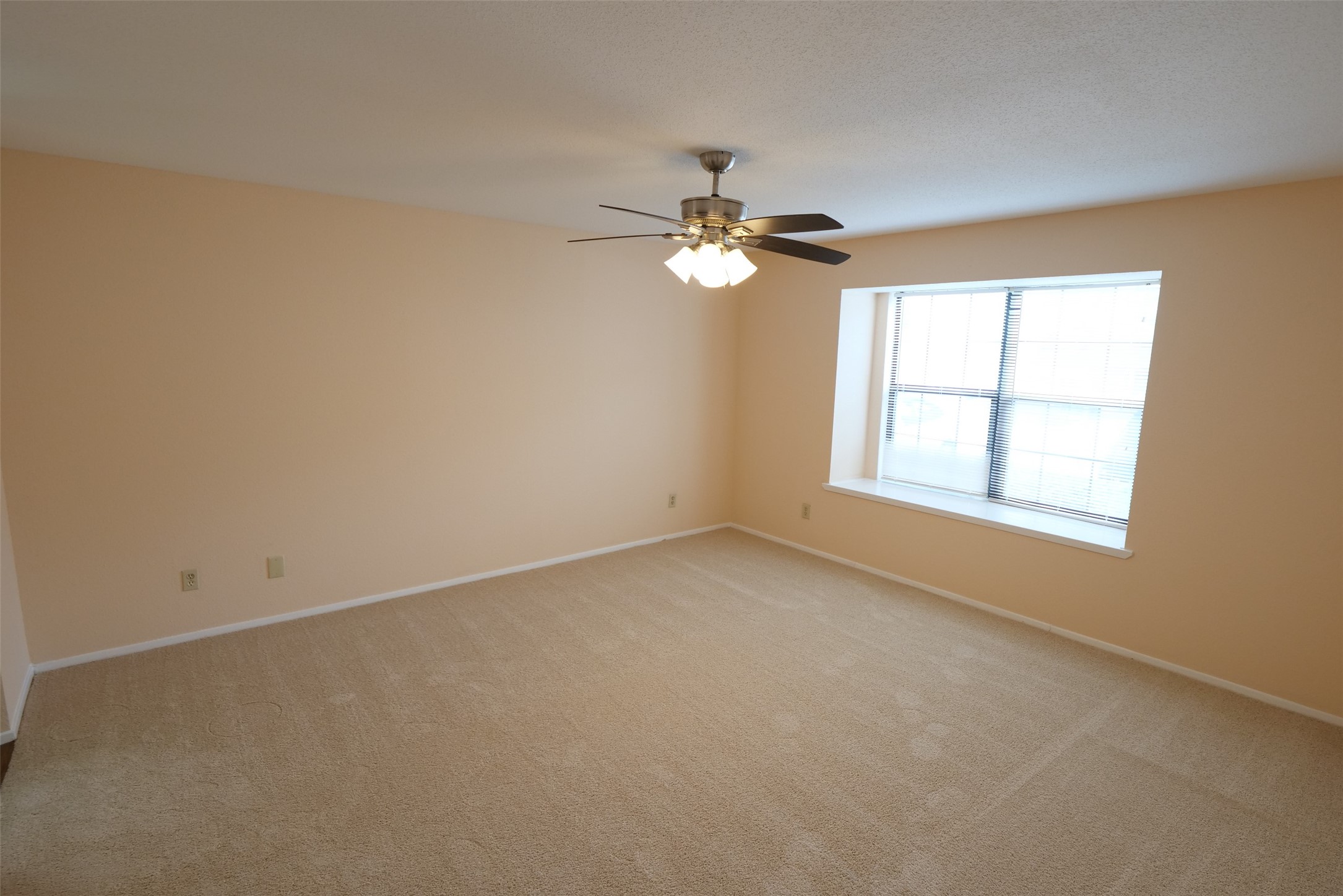 14911 Wunderlich Drive, Unit 2105 Houston, TX 77069 - Photo 11 of 24 an empty room with windows and fan
