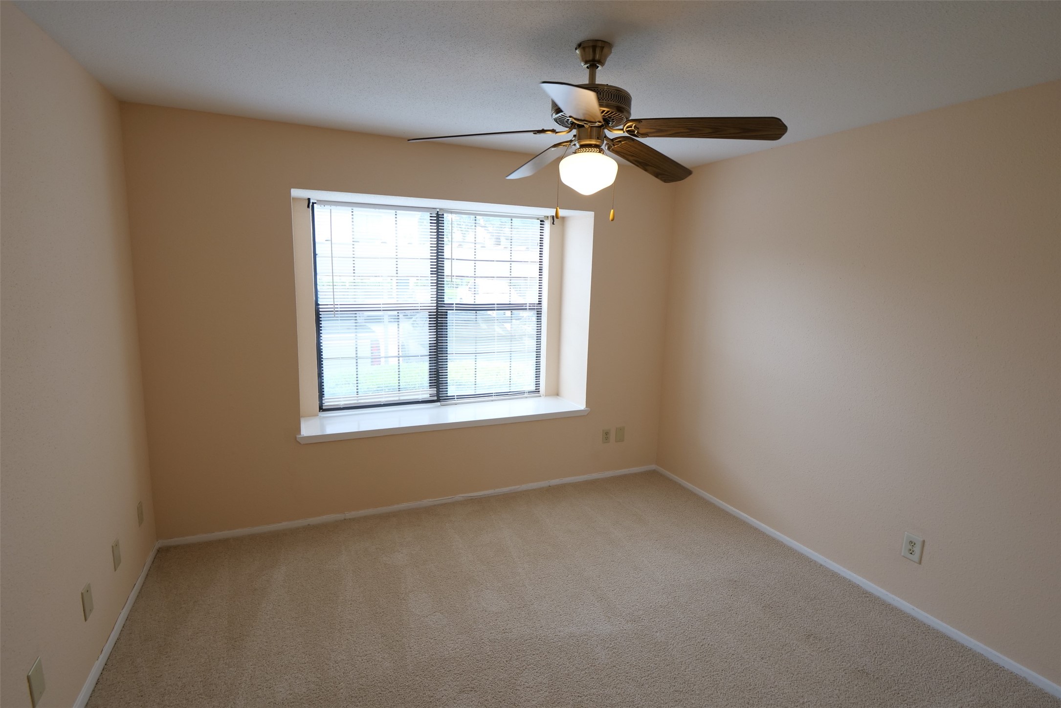 14911 Wunderlich Drive, Unit 2105 Houston, TX 77069 - Photo 16 of 24 a view of empty room with windows and chandelier fan