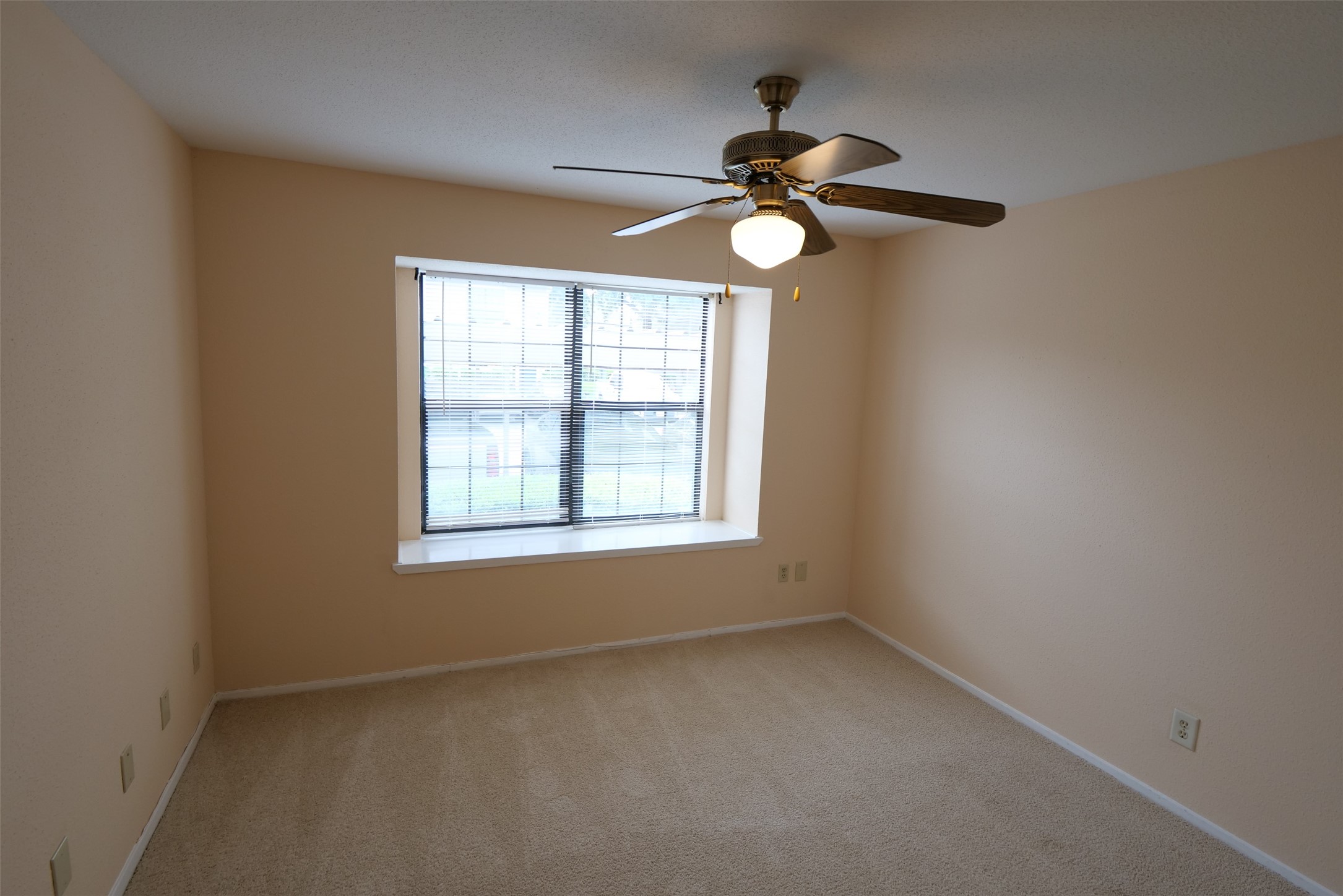 14911 Wunderlich Drive, Unit 2105 Houston, TX 77069 - Photo 17 of 24 an empty room with a window and a fan