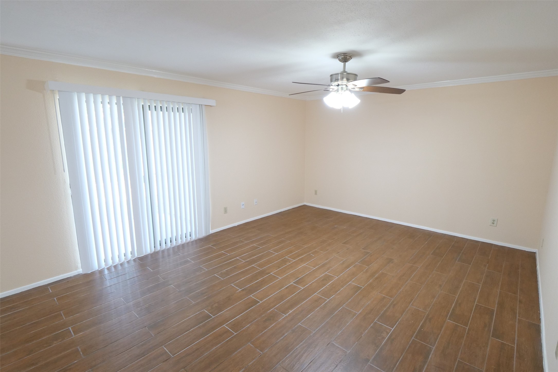 14911 Wunderlich Drive, Unit 2105 Houston, TX 77069 - Photo 7 of 24 wooden floor in an empty room with a window