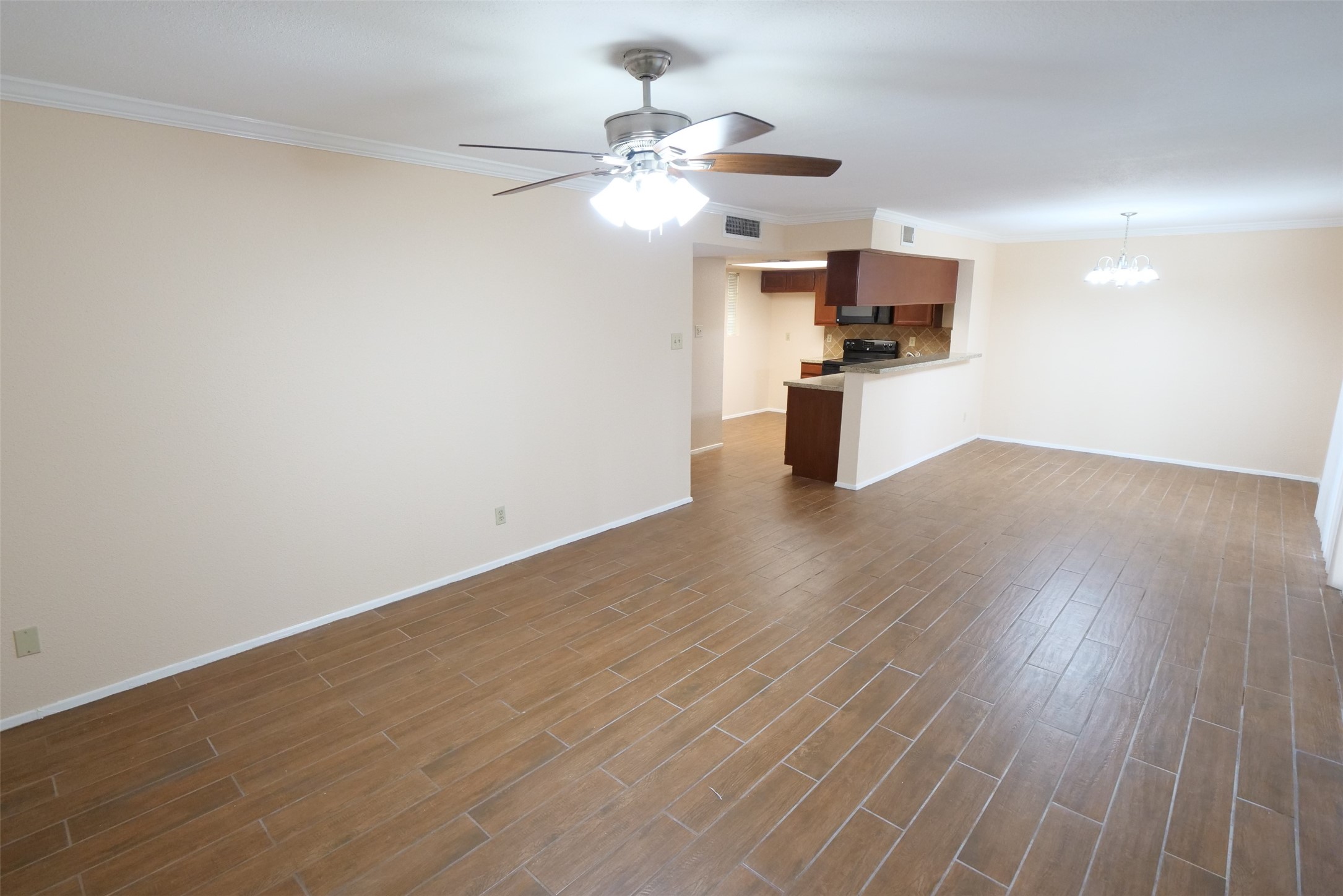 14911 Wunderlich Drive, Unit 2105 Houston, TX 77069 - Photo 8 of 24 wooden floor in an empty room with a window