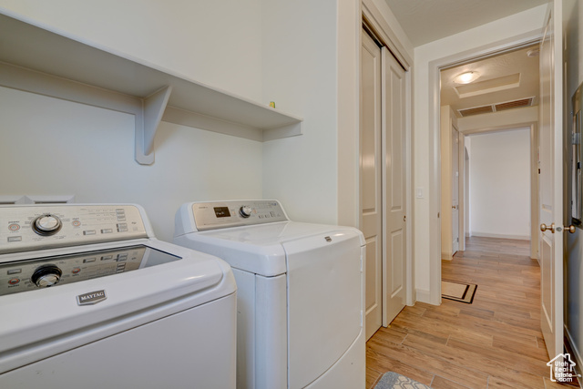 1329 Paseos Street Washington, UT 84780 - Photo 22 of 35 Washroom with light wood-type flooring and washer and dryer