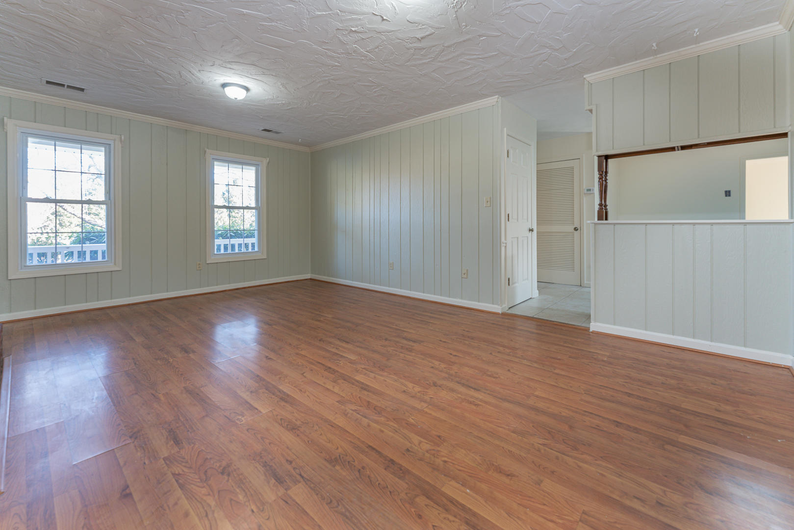 194 Stonebridge Drive Blue Ridge, VA 24064 - Photo 14 of 61 an empty room with wooden floor and windows