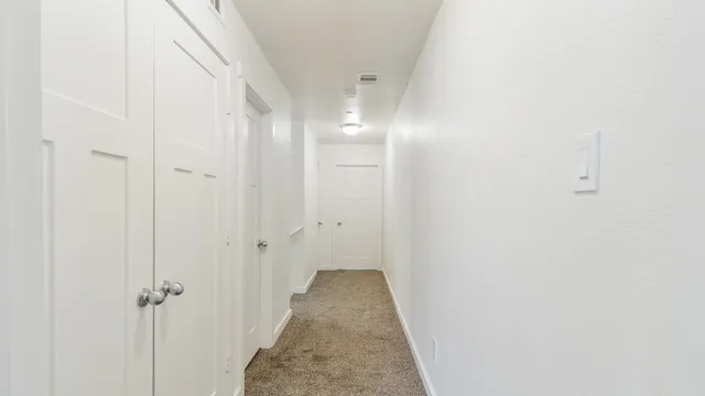 a view of a bathroom from a hallway