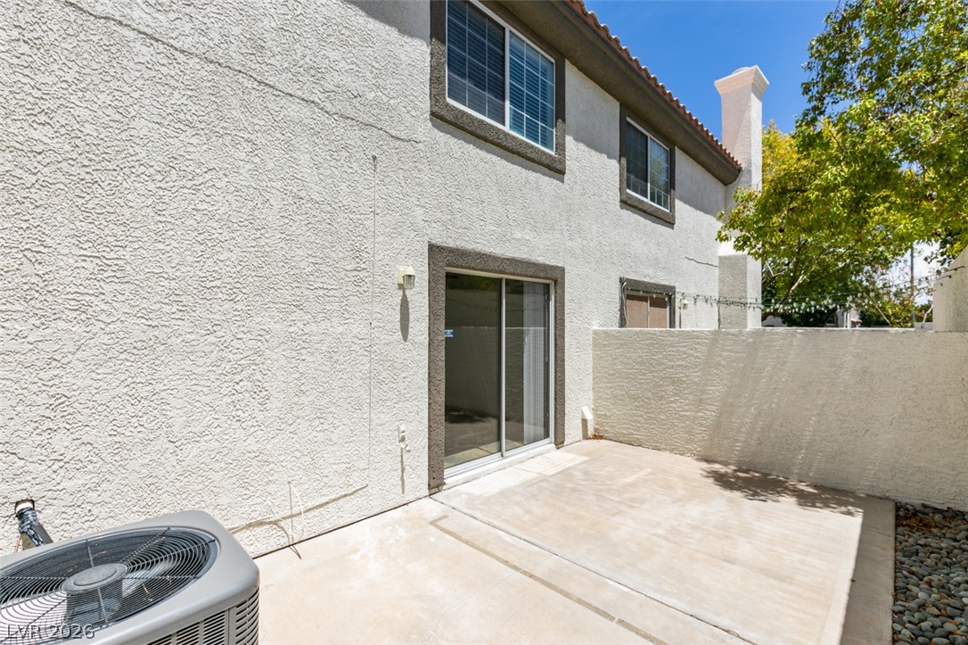 200 Luninborg Street Henderson, NV 89074 - Photo 2 of 40 A spacious patio area extends from the stucco exterior, perfect for outdoor leisure.