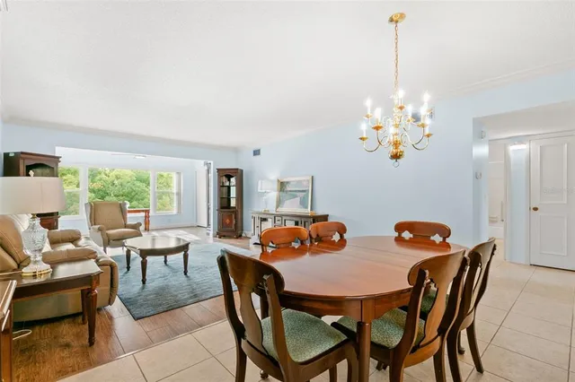a view of a dining room with furniture a chandelier and wooden floor