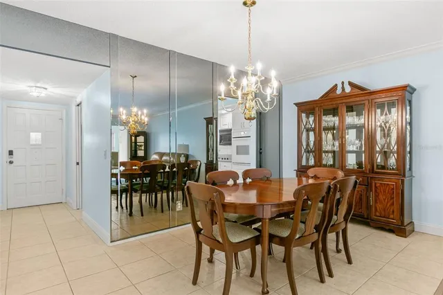 a view of a dining room with furniture and chandelier