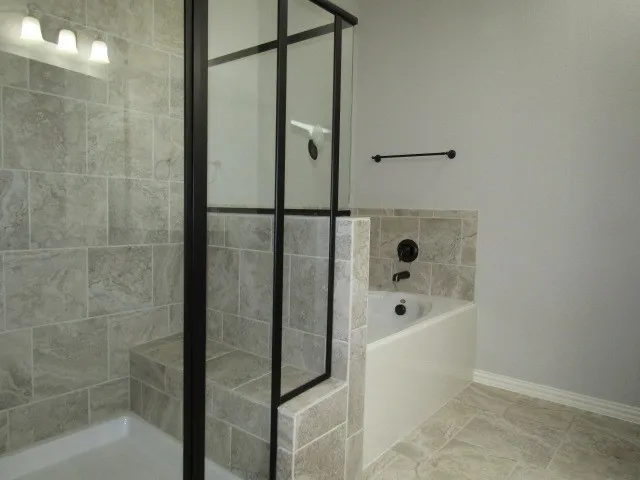 a bathroom with a bathtub and shower