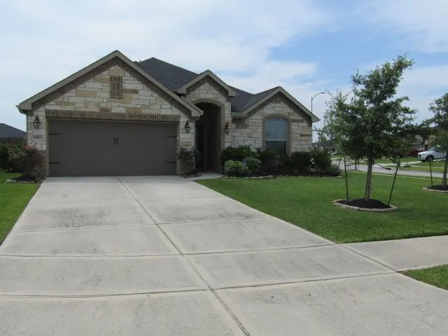 a front view of a house with yard and garage