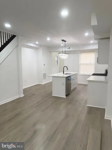 a kitchen with a sink stainless steel appliances and cabinets