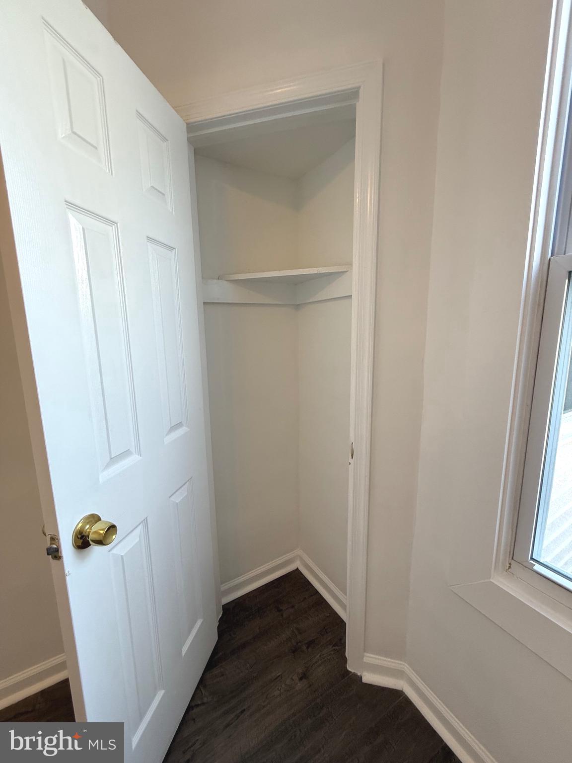 4803 Cordelia Avenue Baltimore, MD 21215 - Photo 19 of 39 an empty room with wooden floor and a window