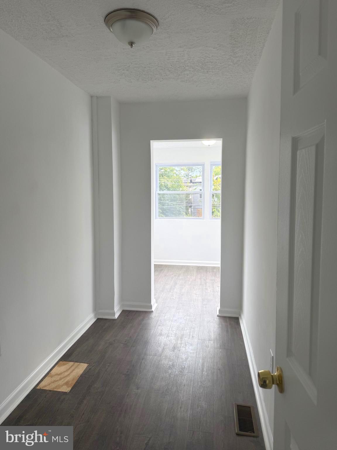 4803 Cordelia Avenue Baltimore, MD 21215 - Photo 21 of 39 an empty room with wooden floor and windows