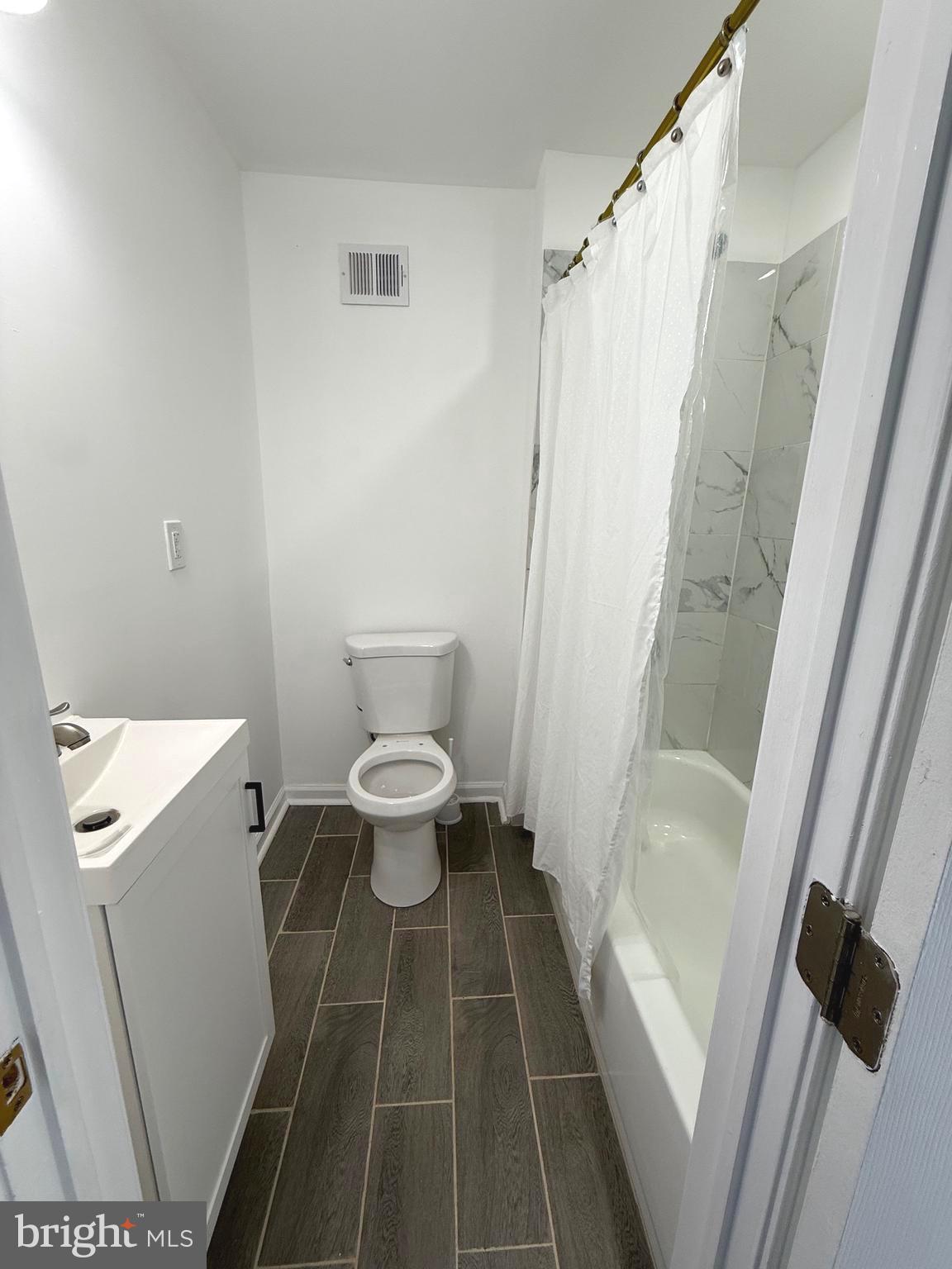4803 Cordelia Avenue Baltimore, MD 21215 - Photo 24 of 39 a bathroom with a toilet and a shower