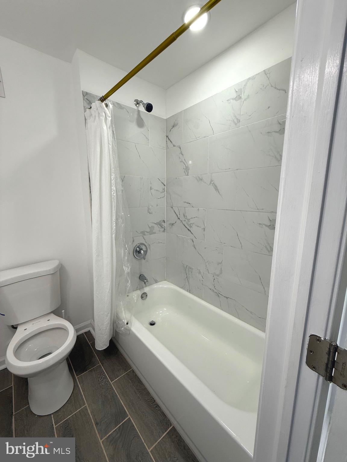 4803 Cordelia Avenue Baltimore, MD 21215 - Photo 26 of 39 a bathroom with a toilet and a shower