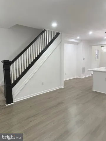 a view of staircase with white walls and railing