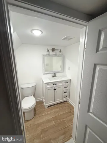 a bathroom with a toilet sink and a mirror