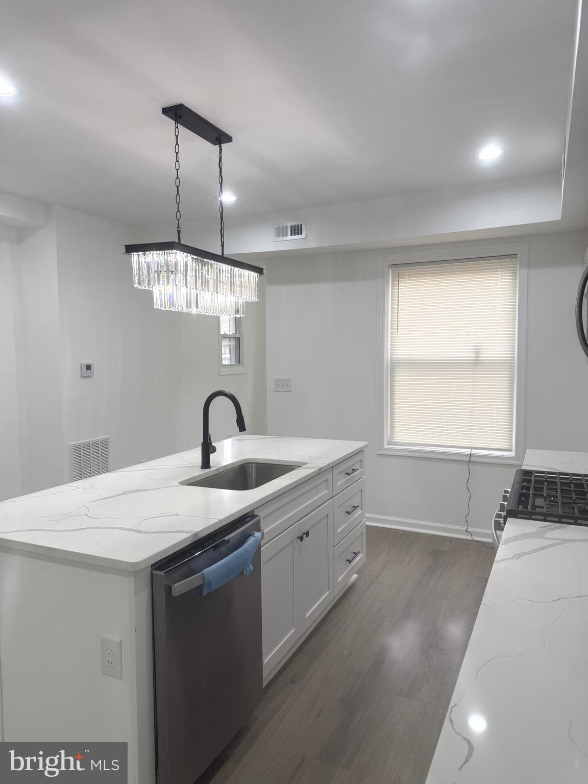 4803 Cordelia Avenue Baltimore, MD 21215 - Photo 7 of 39 a kitchen with a sink a counter space and a window