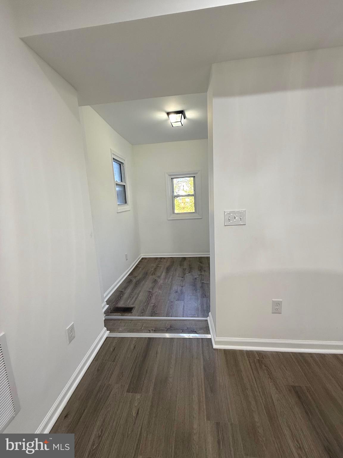 4803 Cordelia Avenue Baltimore, MD 21215 - Photo 10 of 39 an empty room with wooden floor and windows