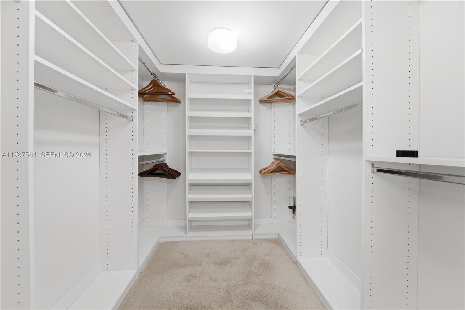 19670 South Beach Road, Unit B323 Tequesta, FL 33469 - Photo 23 of 57 a view of walk in closet with empty racks